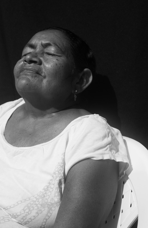 Enalba, 59, one of 12 brothers and sisters, lives in a hand-made home of mud, plastic, and wood, on the side of a hill off the highway in barrio Nari&amp;ntilde;o, in El Carmen. She cooks outside over wood and fire, sells street food from dawn until about 10 am, and then begins cooking lunch and dinner for neighbors to patch together an income. Her two sons and her then husband arrived in El Carmen roughly 35 years ago, when they were displaced from both La Piedra and Respaldo. Down the road, in another part of Nari&amp;ntilde;o, is a small church and school run by a Swiss nun, where Enalba learned to read about 4 years ago.