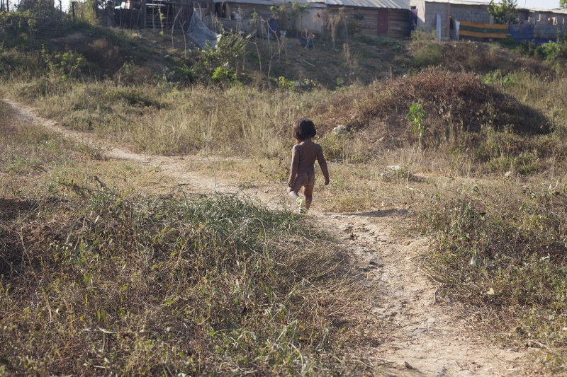 Outside of Bonanza, where La Liga built their houses in 2006, a toddler roams around in socks. Bonanza is a mix of an urban and rural environment. While the displaced community makes up the majority of the population here, private development is beginning to go up around these houses. Those who have been displaced in Colombia often experience displacement more than once. Yuris, for example, has been displaced three times within Cartagena because of insecurity in the barrios.&amp;nbsp;